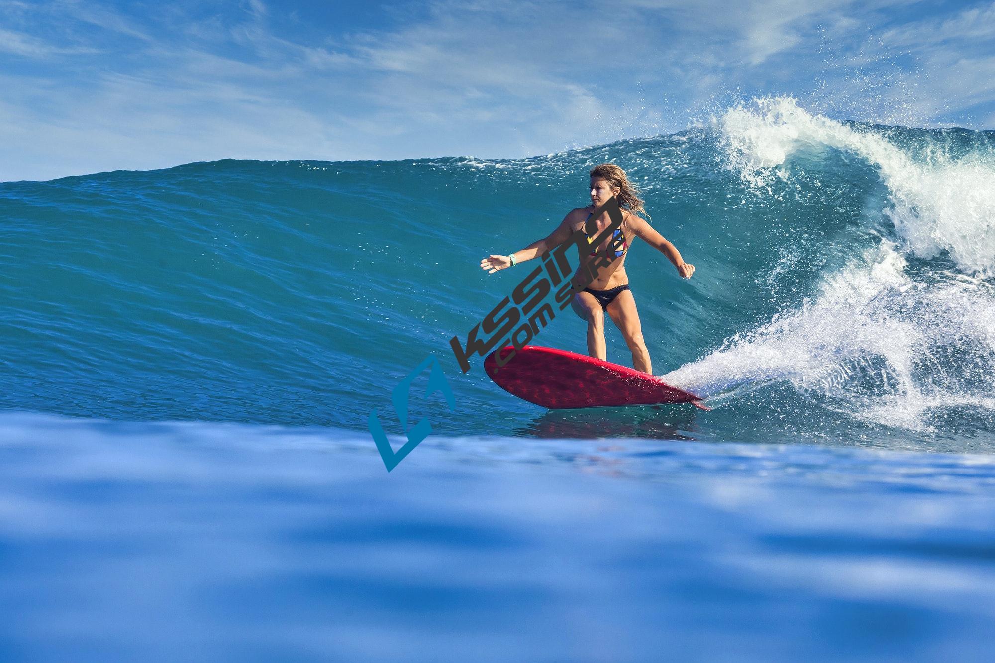 female-surfer-on-a-blue-wave.jpg